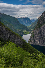 Amazing nature view with fjord and mountains. Beautiful reflection. Location: Scandinavian Mountains, Norway. Artistic picture. Beauty world. The feeling of complete freedom