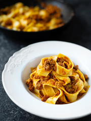rustic italian pappardelle bolognese pasta in meat sauce
