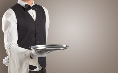 Waiter serving with white gloves and steel tray in an empty space
