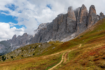 road through the hills to mountain Sella Towers in Dolomites