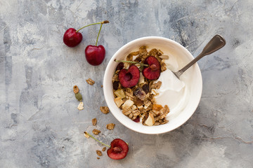 Homemade granola with yogurt and black cherries