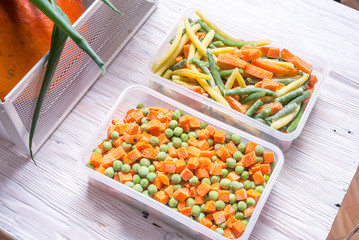 Plastic storage boxes with frozen vegetables