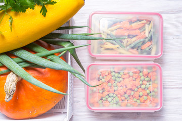 Plastic storage boxes with frozen vegetables