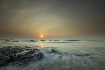 Obraz premium Glorious morning sunrise at Pantai Batu Hitam (Batu Hitam Beach), Kuantan, Pahang. Awesome clouds with ray of light visible.