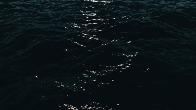 Calm dark ocean waves with moon light reflection. Seamless loop