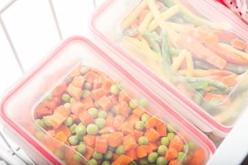 Plastic storage boxes with frozen vegetables