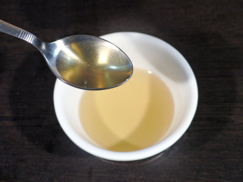 Black Sesame oil in White Bowl on Wooden background, Til ka Tel on Wooden Background,