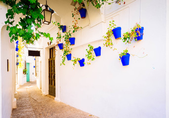 Fototapeta premium Poble Espanyol street, with traditional for Andalusia white walls architecture, Barcelona, Catalonia Spain, toned