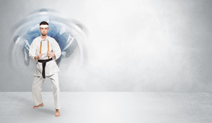 Obraz premium Young businessman in suit fighting with empty wall background 