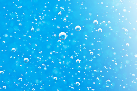 Bubbles of oxygen under water. Water blue structure. Macro