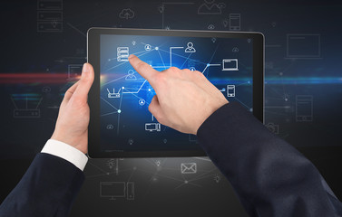 First person view of a hand using tablet with cloud office concept
