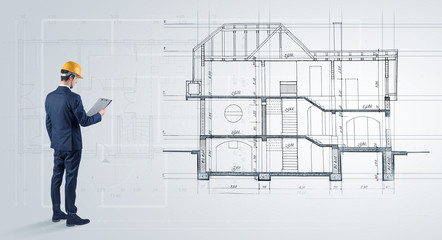 Architect watching a 2 dimension house plan
