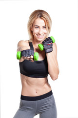 smiling blonde fit woman in sportswear posing with dumbbells isolated on white background