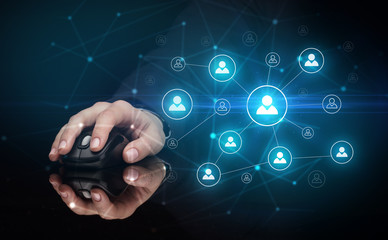 Hand using wireless mouse in a dark environment with human network concept
