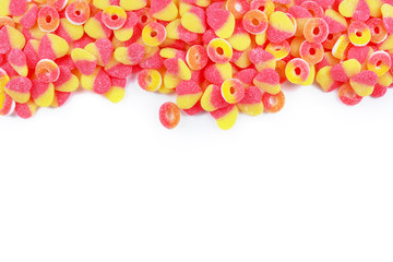 Frame of assorted gummy candies isolated on white. Top view. Space for text or design.