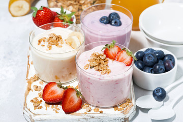 sweet yoghurts with fruits and berries for breakfast, top view