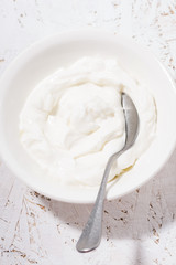 thick Greek yogurt in a bowl, closeup