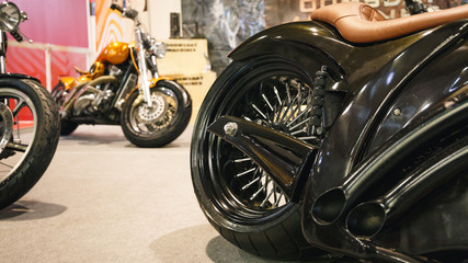 The rear wheel of a motorcycle. A rear view of a motorcycle