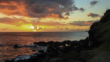 Amazing sunset in the ocean with some small clouds