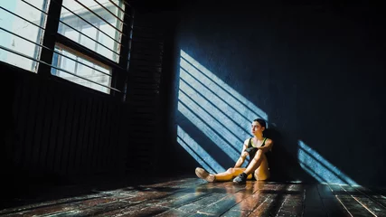 Fotobehang beautiful young boxing woman resting after training after punching in gym. Fit female preparing to boxing competition. Wellness, fighting, motivation, martial arts, self defense concept © yk_stock