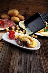 Delicious traditional Swiss melted raclette cheese on diced boiled or baked potato.