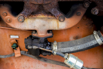 Closeup on Hose and Internal Gears in an Antique Orange Tractor