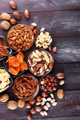 dried fruits and assorted nuts composition on rustic table