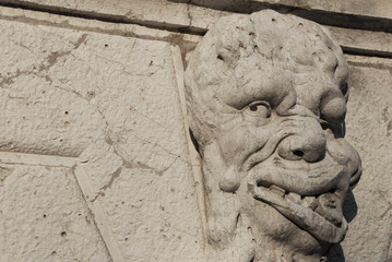 Grotesque in Venice. Bizarre monster guardian head on Santa Formosa Church bell tower (17th century)