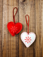 red and white heart with snowflake on wooden background, copy space