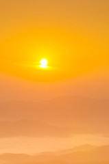 Sunrise over mountain,covered with fog , soft focus.