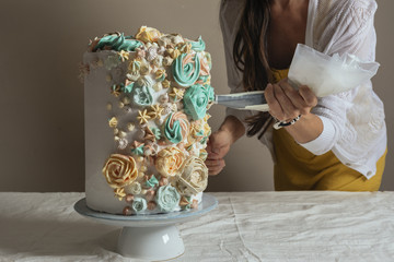 Women hand decorating with a pastry bag with cream