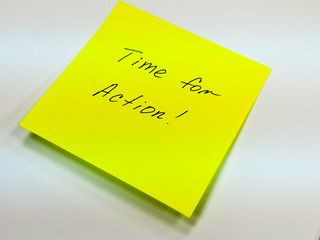 Sticky note with text time for action, motivation