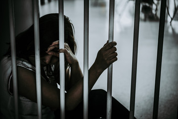 Portrait of woman desperate to catch the iron prison,prisoner concept,thailand people,Hope to be...