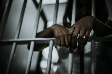 Portrait of woman desperate to catch the iron prison,prisoner concept,thailand people,Hope to be...