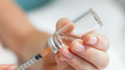 Macro image of syringe needle in ampule with medicines