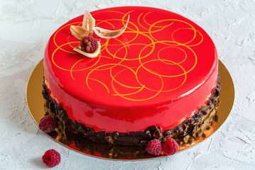 Modern mousse cake with glaze and chocolate decoration.
