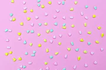 Multicolored candy on a pink background