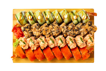 Top view set of sushi rolls with lava maki topping on wooden board isolated at white background.