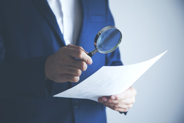 man hand document with magnifier