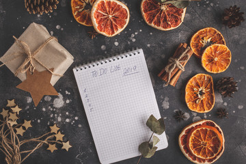 To do list for the new year on a dark background Christmas decorations. Christmas flat lay.