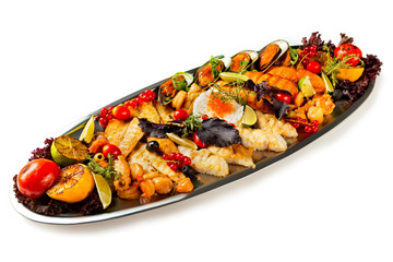 Top view metal dish set of seafood, fish and vegetables isolated at white background.