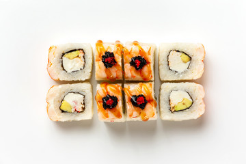 Top view set of sushi rolls with cheese, avocado and teriyaki topping isolated at white background.