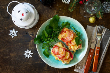 Meat chops with tomato on plate at Christmas style decorated wooden background. Top view flat lay background. Copy space.