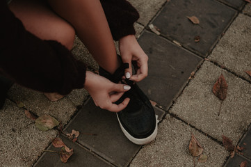 Woman tying shoelaces after exercises