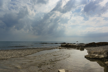 The confluence of the Sukko river in the Black sea. Gloomy cloudy day
