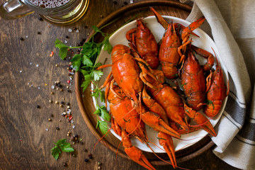 Boiled Crawfish and Fresh Beer in Beakers on a wooden table. Appetizer protein. Top view flat lay background. Copy space.