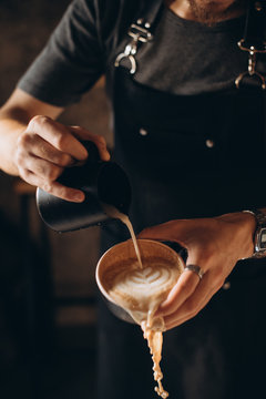 Barista pouring coffee into a cup