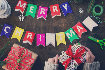Merry Christmas background, xmas gift box, branch of a Christmas tree and decorations on rustic background. Toned image. © elena_hramowa