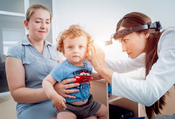 Otolaryngologist examines little boy. Medical equipment