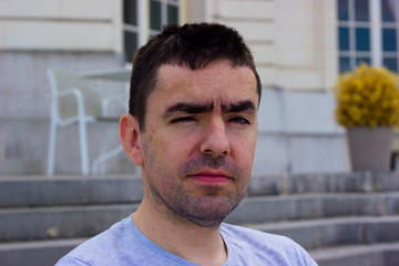Obraz premium Unshaven middle-aged man with a displeased expression